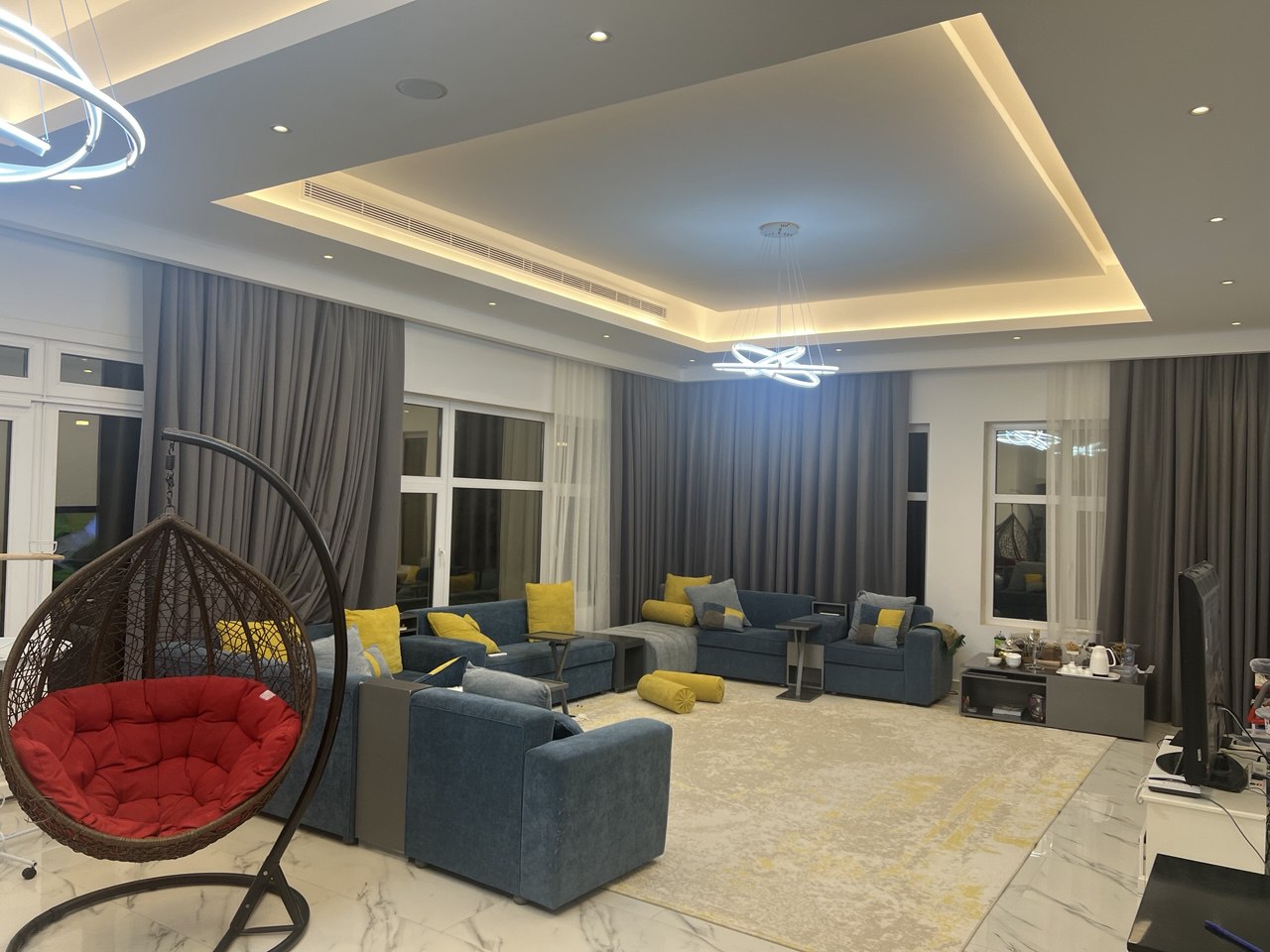 Premium villa living room with ceiling lighting and lounge furniture