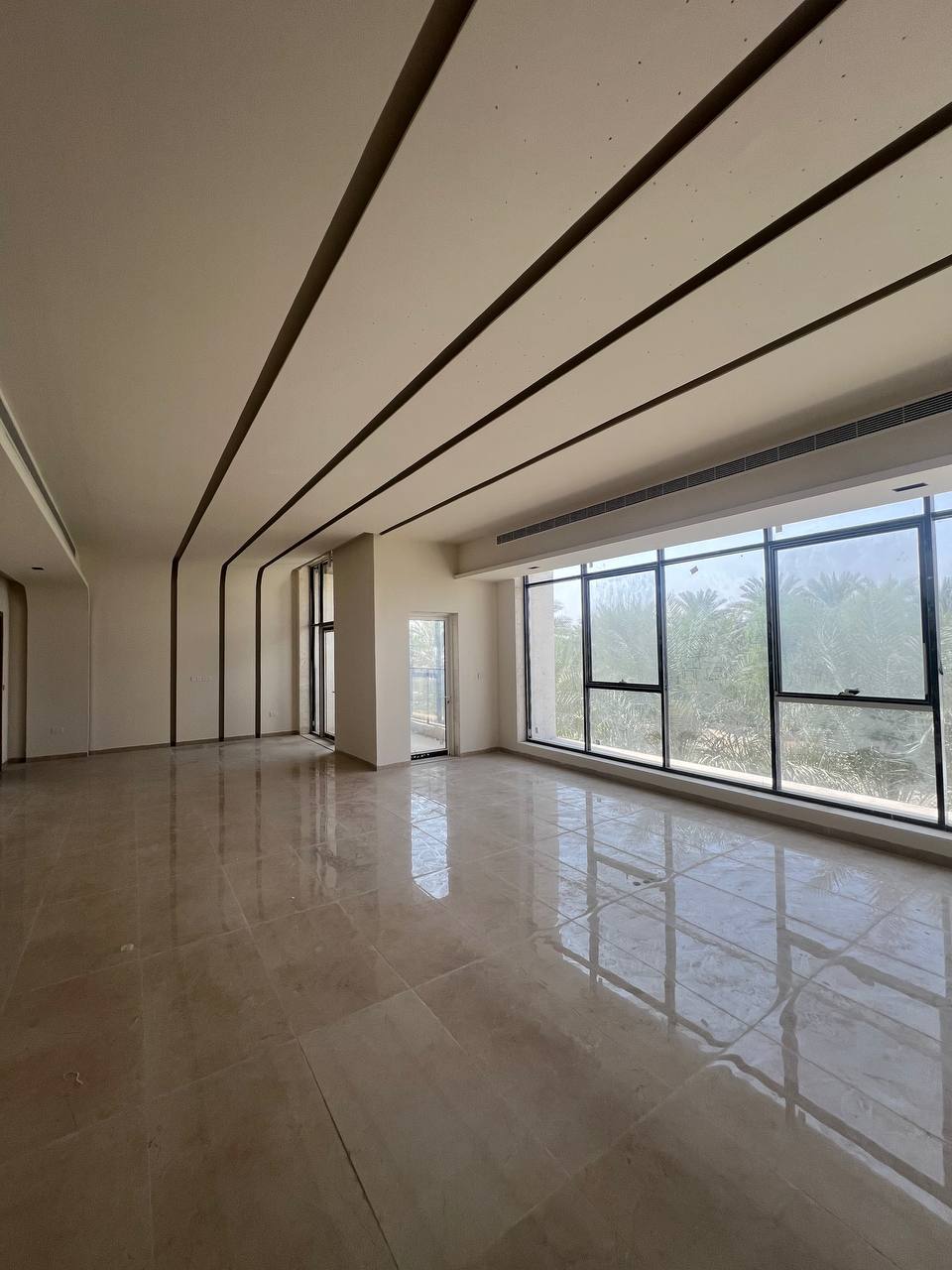 Open interior room prepared with flooring and large windows
